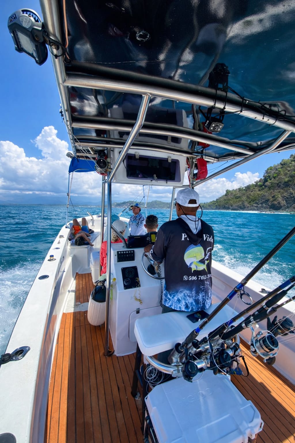 Captain Oscar at the helm heading out to fish